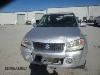 2006 Suzuki Grand Vitara z VIN JS3TE941364101882, wystawiony jako Copart lot #84143364 z przebiegiem 148 560 mil mil oraz Szkody całkowita. Historia ofert i sprzedaży dostępna na DreamBid. Obrazek 12.