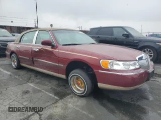 1999 Lincoln Town Car Signature with VIN 1LNHM82W7XY612906, listed as a Copart auction lot 50777435 with 110,414 mi miles and Salvage title. Bid and sale history available at DreamBid. Image 4.