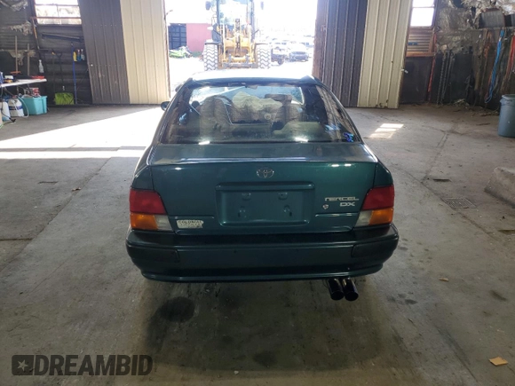 1996 Toyota Tercel DX z VIN JT2BC52L7T7044201, wystawiony jako Copart lot #77190074 z przebiegiem Nie podano mil oraz Szkoda całkowita • Salvage title. Historia ofert i sprzedaży dostępna na DreamBid. Obrazek 6.