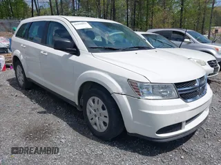 2015 Dodge Journey American Value z VIN 3C4PDCAB2FT588032, wystawiony jako IAAI lot #41928853 z przebiegiem 142 629 mil mil oraz . Historia ofert i sprzedaży dostępna na DreamBid. Obrazek 1.