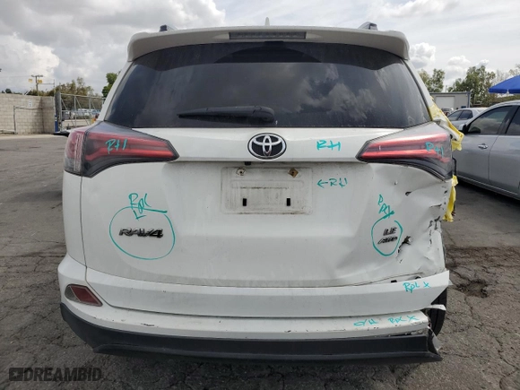 2018 Toyota RAV4 LE with VIN JTMBFREV9JD256759, listed as a Copart auction lot 51165835 with 128,253 mi miles and Salvage Title. Bid and sale history available at carsss.com. Image 6.