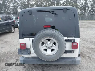 2006 Jeep Wrangler Sport Right Hand Drive with VIN 1J4F449S16P709895, listed as a IAAI auction lot 41349311 with 157,125 mi miles. Bid and sale history available at carsss.com. Image 16.