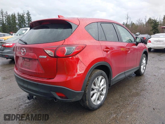 2015 Mazda CX-5 Grand Touring with VIN JM3KE4DY0F0479392, listed as a IAAI auction lot 41659415 with 141,403 mi miles. Bid and sale history available at carsss.com. Image 4.