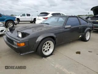 1985 Toyota Supra z VIN JT2MA67L3F0151708, wystawiony jako Copart lot #74672844 z przebiegiem 60 346 mil mil oraz Szkoda całkowita • Salvage title. Historia ofert i sprzedaży dostępna na DreamBid. Obrazek 1.