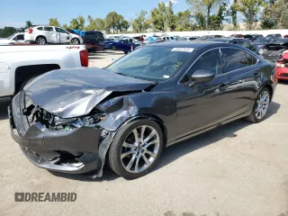 2014 Mazda 6 i Grand Touring с VIN JM1GJ1W67E1135264, выставлен на аукционе Copart как лот 70587624 с пробегом 86 926 миль миль и Списание • Salvage title. История ставок и продаж доступна на DreamBid. Изображение 1.