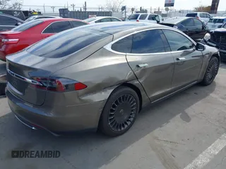 2015 Tesla Model S 85 with VIN 5YJSA1E14FF120455, listed as a IAAI auction lot 42053306 with 62,817 mi miles and . Bid and sale history available at DreamBid. Image 4.