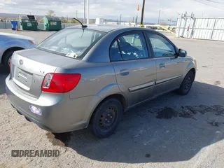 2010 Kia Rio LX with VIN KNADH4A34A6674027, listed as a IAAI auction lot 41804686 with 113,528 mi miles. Bid and sale history available at carsss.com. Image 4.
