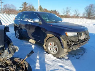 2014 Jeep Grand Cherokee Overland with VIN 1C4RJFCG1EC200570, listed as a IAAI auction lot 41301398 with 183,986 mi miles. Bid and sale history available at carsss.com. Image 1.