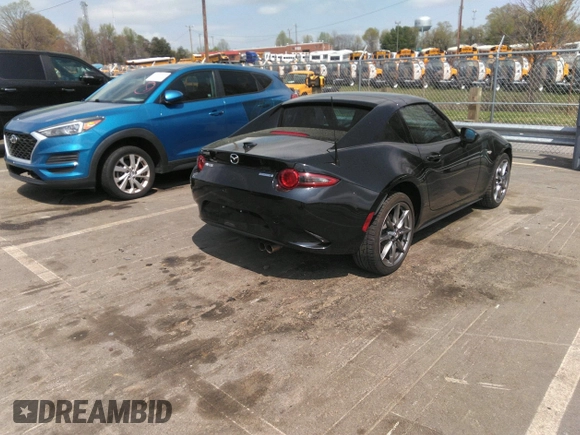 2021 Mazda MX-5 Miata Grand Touring z VIN JM1NDAM75M0451597, wystawiony jako IAAI lot #41932712 z przebiegiem 61 710 mil mil oraz . Historia ofert i sprzedaży dostępna na DreamBid. Obrazek 4.