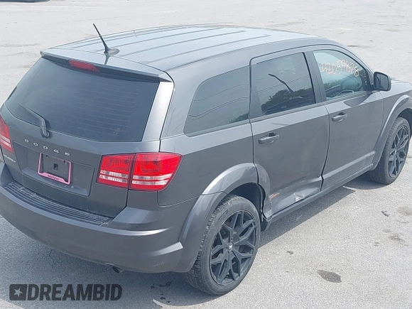 2015 Dodge Journey SE z VIN 3C4PDCAB4FT675074, wystawiony jako IAAI lot #42059878 z przebiegiem 99 947 mil mil oraz . Historia ofert i sprzedaży dostępna na DreamBid. Obrazek 14.