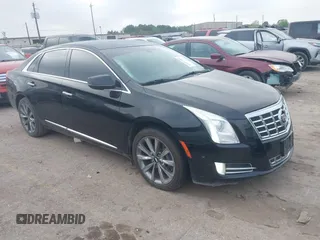 2014 Cadillac XTS Luxury z VIN 2G61M5S30E9326197, wystawiony jako IAAI lot #41887002 z przebiegiem 152 401 mil mil oraz . Historia ofert i sprzedaży dostępna na DreamBid. Obrazek 1.