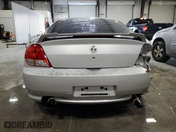 2006 Hyundai Tiburon GT z VIN KMHHN65F96U203924, wystawiony jako Copart lot #43624185 z przebiegiem 120 403 mil mil oraz Szkoda całkowita • Salvage title. Historia ofert i sprzedaży dostępna na DreamBid. Obrazek 6.