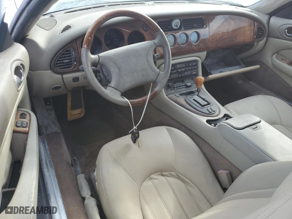 1997 Jaguar XK8 with VIN SAJGX2748VC001869, listed as a Copart auction lot 75406464 with 0 mi miles and Salvage Title. Bid and sale history available at carsss.com. Image 8.