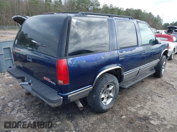 1997 GMC Yukon with VIN 1GKEK13R6VJ715421, listed as a IAAI auction lot 41811398 with 214,735 mi miles. Bid and sale history available at carsss.com. Image 4.