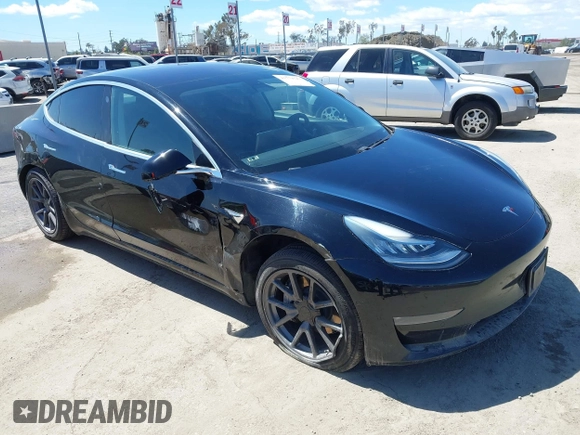 2019 Tesla Model 3 Mid Range with VIN 5YJ3E1EA3KF325056, listed as a IAAI auction lot 41771543 with 183,157 mi miles and . Bid and sale history available at carsss.com. Image 1.