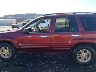 1999 Jeep Grand Cherokee Limited with VIN 1J4GW68N3XC770468, listed as a IAAI auction lot 41793600 with 65,277 mi miles. Bid and sale history available at carsss.com. Image 14.