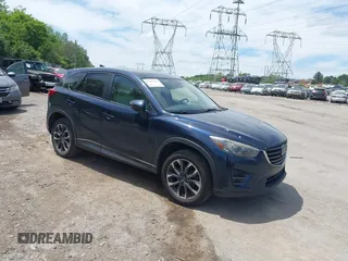2016 Mazda CX-5 Grand Touring z VIN JM3KE4DY1G0817562, wystawiony jako IAAI lot #42289929 z przebiegiem 135 476 mil mil oraz . Historia ofert i sprzedaży dostępna na DreamBid. Obrazek 1.
