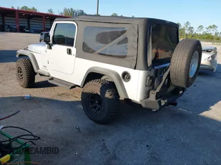 2005 Jeep Wrangler Unlimited with VIN 1J4FA44S65P335444, listed as a IAAI auction lot 41731093 with 143,918 mi miles. Bid and sale history available at carsss.com. Image 3.