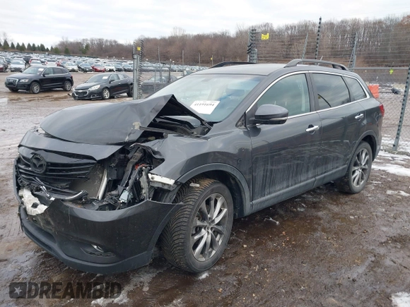 2015 Mazda CX-9 Grand Touring with VIN JM3TB2DAXF0447537, listed as a IAAI auction lot 41191694 with 157,113 mi miles. Bid and sale history available at carsss.com. Image 2.