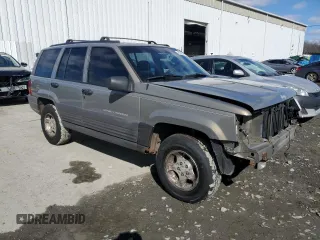 1997 Jeep Grand Cherokee Laredo with VIN 1J4GZ58SXVC569171, listed as a Copart auction lot 45657745 with 101,648 mi miles and Salvage Title. Bid and sale history available at carsss.com. Image 4.