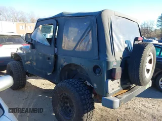 2005 Jeep Wrangler SE with VIN 1J4FA29155P366432, listed as a IAAI auction lot 41260303 with 134,021 mi miles. Bid and sale history available at carsss.com. Image 3.