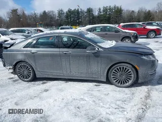 2015 Lincoln MKZ z VIN 3LN6L2J99FR606377, wystawiony jako IAAI lot #41597537 z przebiegiem 110 746 mil mil oraz . Historia ofert i sprzedaży dostępna na DreamBid. Obrazek 13.