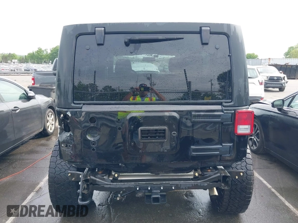 2015 Jeep Wrangler Unlimited Willys Wheeler with VIN 1C4BJWDG4FL687829, listed as a IAAI auction lot 42099147 with 98,969 mi miles and . Bid and sale history available at DreamBid. Image 17.