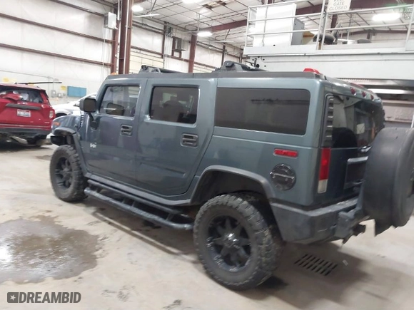 2005 Hummer H2 SUV with VIN 5GRGN23U65H132505, listed as a IAAI auction lot 41515346 with 140,944 mi miles. Bid and sale history available at carsss.com. Image 3.