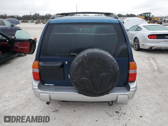 2002 Chevrolet Tracker LT with VIN 2CNBE634126928532, listed as a Copart auction lot 76990704 with Not provided miles and Salvage title. Bid and sale history available at DreamBid. Image 6.