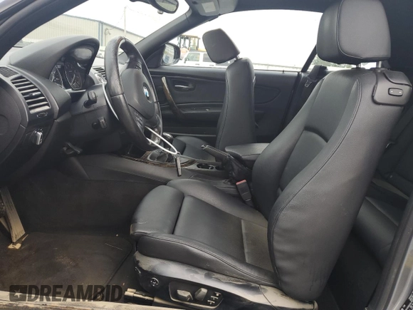 2012 BMW 1 Series 135i with VIN WBAUN7C59CVM26082, listed as a Copart auction lot 74711754 with 77,152 mi miles and Salvage title. Bid and sale history available at DreamBid. Image 7.