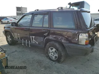 1993 Jeep Grand Cherokee Laredo with VIN 1J4GZ58S8PC656490, listed as a Copart auction lot 49377485 with 236,215 mi miles and Salvage Title. Bid and sale history available at carsss.com. Image 2.