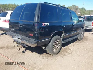 1999 GMC Yukon with VIN 1GKEK13R4XJ762708, listed as a IAAI auction lot 41653291 with 200,240 mi miles. Bid and sale history available at carsss.com. Image 4.