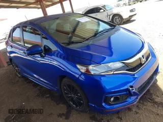 2018 Honda Fit Sport z VIN 3HGGK5G69JM718338, wystawiony jako IAAI lot #42272771 z przebiegiem 57 602 mil mil oraz . Historia ofert i sprzedaży dostępna na DreamBid. Obrazek 1.