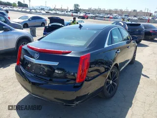2013 Cadillac XTS Luxury z VIN 2G61P5S30D9220113, wystawiony jako IAAI lot #41970214 z przebiegiem 52 476 mil mil oraz . Historia ofert i sprzedaży dostępna na DreamBid. Obrazek 4.