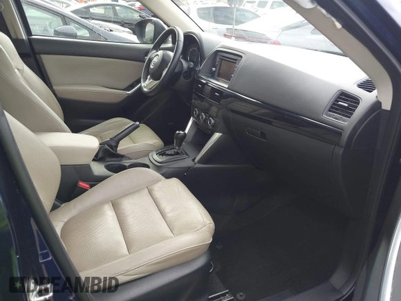 2014 Mazda CX-5 Grand Touring with VIN JM3KE2DY1E0307911, listed as a IAAI auction lot 42064898 with 133,934 mi miles. Bid and sale history available at carsss.com. Image 5.
