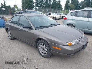 2000 Saturn SL z VIN 1G8ZJ5274YZ267302, wystawiony jako IAAI lot #42478793 z przebiegiem 183 148 mil mil oraz . Historia ofert i sprzedaży dostępna na DreamBid. Obrazek 1.