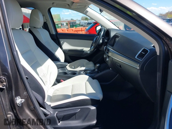 2016 Mazda CX-5 Grand Touring with VIN JM3KE2DYXG0773663, listed as a IAAI auction lot 41896367 with 86,571 mi miles and . Bid and sale history available at DreamBid. Image 5.