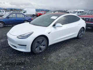 2018 Tesla Model 3 Long Range Battery with VIN 5YJ3E1EA3JF013253, listed as a IAAI auction lot 41752102 with 84,459 mi miles. Bid and sale history available at carsss.com. Image 2.
