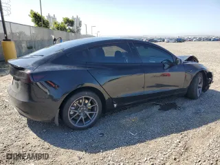 2021 Tesla Model 3 Standard Range Plus with VIN 5YJ3E1EA6MF067702, listed as a Copart auction lot 52048315 with 72,974 mi miles and Salvage Title. Bid and sale history available at carsss.com. Image 3.