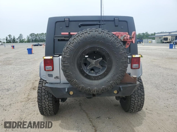 2013 Jeep Wrangler Unlimited Rubicon with VIN 1C4BJWFG5DL661282, listed as a Copart auction lot 57471035 with 128,400 mi miles and Salvage title. Bid and sale history available at DreamBid. Image 6.
