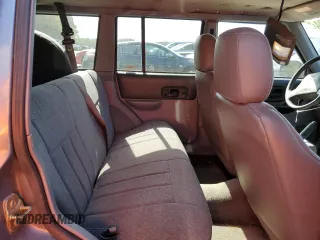 1998 Jeep Cherokee Sport with VIN 1J4FT68S4WL121559, listed as a Copart auction lot 77387794 with 163,453 mi miles and Salvage Title. Bid and sale history available at carsss.com. Image 11.