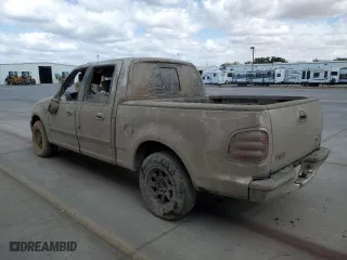 2001 Ford F-150 SuperCrew XLT with VIN 1FTRW07W01KA40634, listed as a Copart auction lot 71674184 with 0 mi miles and Salvage Title. Bid and sale history available at carsss.com. Image 2.