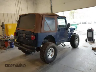 2003 Jeep Wrangler Sport with VIN 1J4FA49S53P311822, listed as a IAAI auction lot 41621710 with 156,023 mi miles. Bid and sale history available at carsss.com. Image 4.