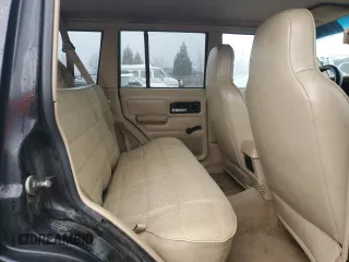 1996 Jeep Cherokee Sport with VIN 1J4FJ68S0TL288244, listed as a Copart auction lot 87801025 with 218,356 mi miles and Salvage Title. Bid and sale history available at carsss.com. Image 11.