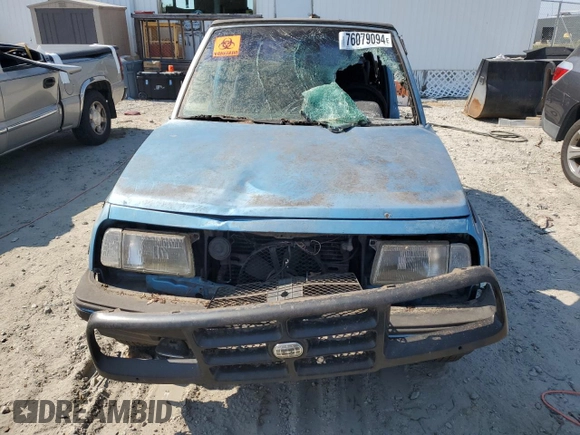 1995 Geo Tracker z VIN 2CNBE18UXS6930601, wystawiony jako Copart lot #76079094 z przebiegiem 276 136 mil mil oraz Szkody całkowita. Historia ofert i sprzedaży dostępna na DreamBid. Obrazek 5.