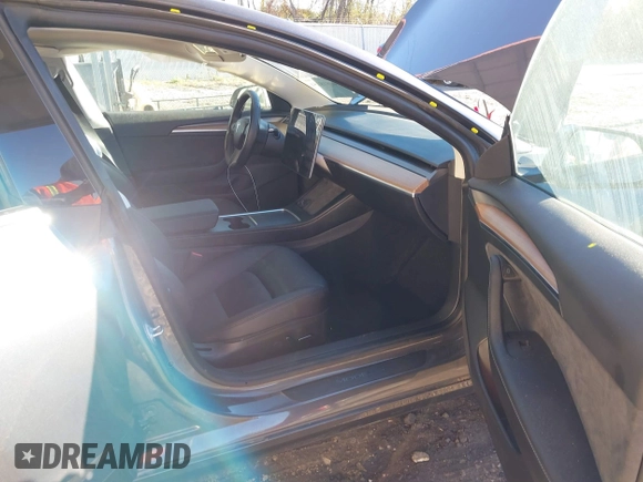 2023 Tesla Model 3 with VIN 5YJ3E1EA3PF673642, listed as a IAAI auction lot 40818151 with 12,293 mi miles and . Bid and sale history available at carsss.com. Image 5.
