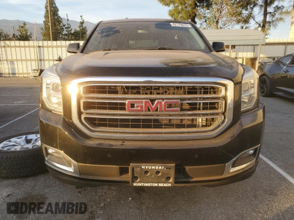 2015 GMC Yukon SLT with VIN 1GKS1BKC9FR144289, listed as a Copart auction lot 42179675 with 122,807 mi miles and Salvage Title. Bid and sale history available at carsss.com. Image 5.