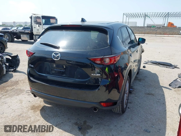 2020 Mazda CX-5 Grand Touring with VIN JM3KFADM1L0781634, listed as a IAAI auction lot 42333769 with 103,080 mi miles and . Bid and sale history available at DreamBid. Image 4.