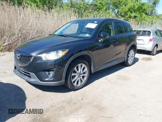 2013 Mazda CX-5 Grand Touring with VIN JM3KE4DE6D0127601, listed as a IAAI auction lot 42143558 with 95,719 mi miles and . Bid and sale history available at DreamBid. Image 2.