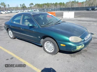 1999 Mercury Sable LS z VIN 1MEFM53S7XA612899, wystawiony jako IAAI lot #41687188 z przebiegiem 155 128 mil mil oraz . Historia ofert i sprzedaży dostępna na DreamBid. Obrazek 1.